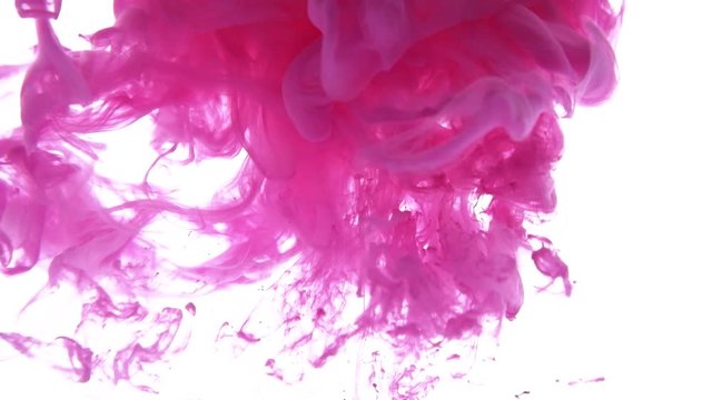 Pink ink dropped in water on white background