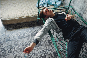 Male druggy sleeping in bed after dose