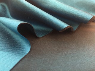 Woven texture of silk fabric or yarn turquois beige color changeable for background. Advertising...