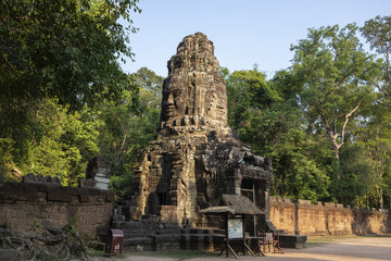 Ancient ruins of Ta Prohm temple in Angkor Wat complex, Cambodia. Tower with Buddha face. Stone temple ruin.