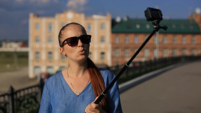 woman blogger shoots video on action camera for his blog on social networks.