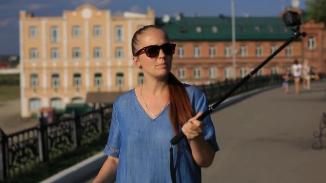 woman blogger shoots video on action camera for his blog on social networks.