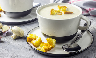 mushroom cream soup on white wooden board. top view
