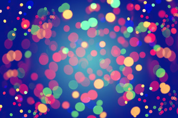 Colorful bokeh lights on blue background.