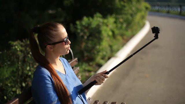 woman blogger shoots video on action camera for his blog on social networks.
