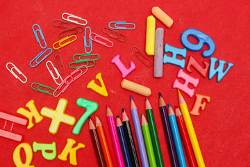 School supplies on red background and back to school concept