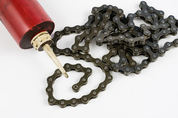 Lubricating the bicycle chain with liquid lubricant. Periodic servicing of parts for two-wheelers.
