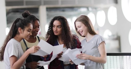High school female students opening their exam results