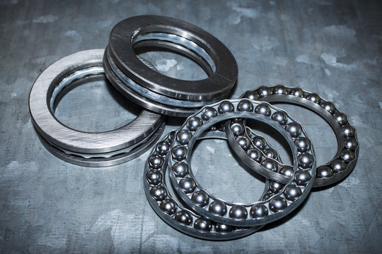 Industrial bearings and ball cages for rolls or wheels