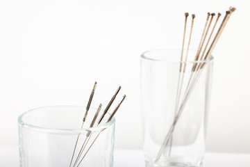 Silver needles for traditional Chinese medicine acupuncture. Close-up. White background.