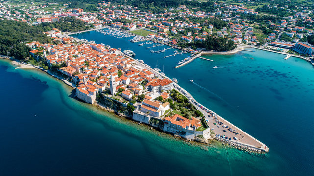 Rab is a Croatian island in the Adriatic Sea, old town encircled by ancient walls. The town&rsquo;s 4 prominent church bell towers include the Romanesque tower at the Cathedral Svete Marije (St. Mary)