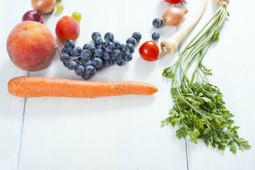 autumnal fruits and vegetables on white wooden table