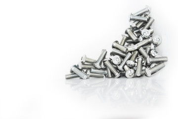 A lot of galvanized industrial screws on a pile isolated in front of a white background