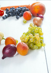 autumnal fruits and vegetables on white wooden table