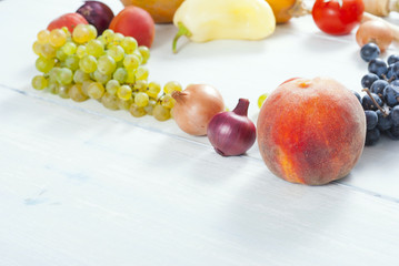 autumnal fruits and vegetables on white wooden table