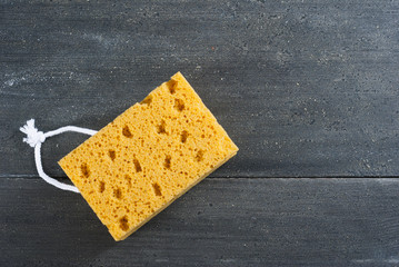 foam sponge on dark wooden table