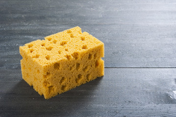 foam sponge on dark wooden table
