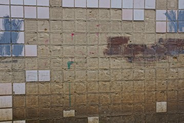 Obraz premium gray brown texture from plaster on the wall and old square tile