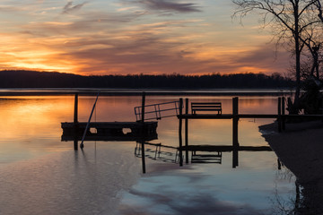 Fototapeta na wymiar Sunset Over Dock with Frozen River