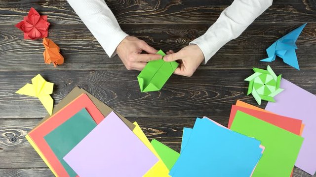 Hands making origami figure. Creative origami figures. Art of origami.