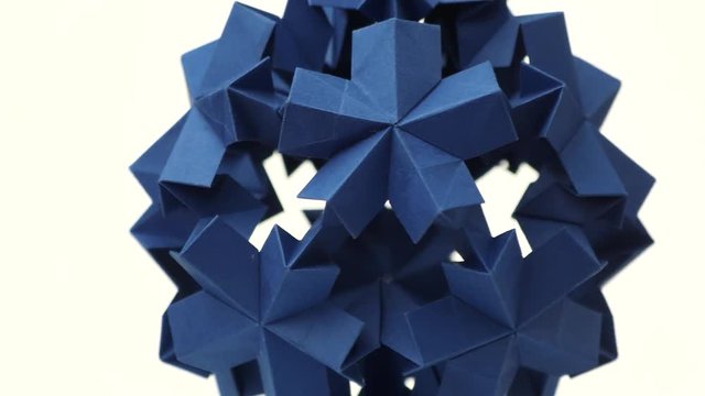 Blue origami transforming spiky ball. Bright isolated background.