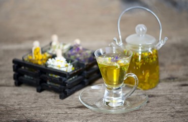 Cup of herbal tea with wild flowers and various herbs 