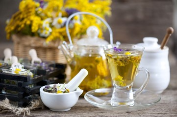 Cup of herbal tea with wild flowers and various herbs 