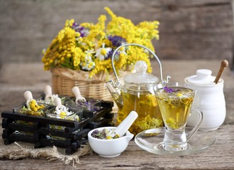Cup of herbal tea with wild flowers and various herbs 