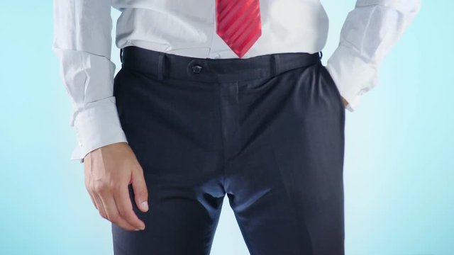 a person has problems with the genitourinary system. businessman on a colored background. 4k, close-up, slow-motion shooting.