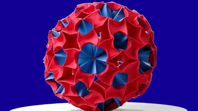 Red origami magic ball. Blue hromakey background.