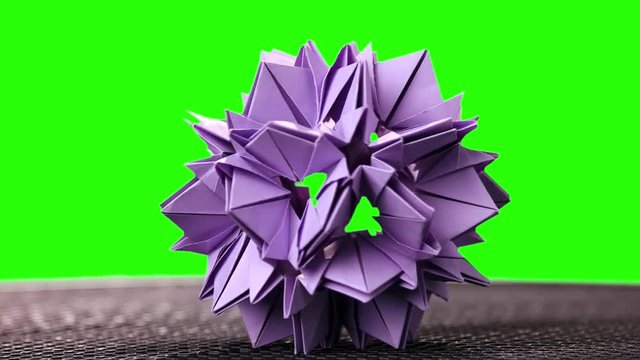 3d purple origami spiky ball exposition. Green hromakey background for keying.