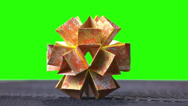 Origami Flower Ball Origami. Ball modular origami ball template. Green hromakey background for keying.