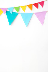 Colorful party flags hanging on white wall  background, birthday, anniversary, celebrate event,...