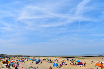 Beachgoers making the most of the sunshine at Minnis Bay over the weekend. Birchington, Kent, England