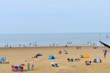 Fototapeta na wymiar Tourists on their summer holidays, Minnis Bay, Birchington, Kent, UK, August, 2018