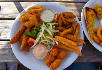 Deep fried whitebait plaice goujons jumbo battered prawns wholetail scampi calamari and dips. Typical British pub food served at the seaside King Ethelbert Inn in Reculver near Herne Bay, Kent England
