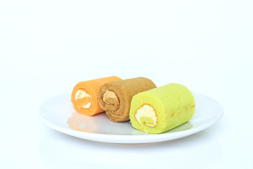 green chocolate orange cake roll on white placed on white background.
