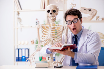 Crazy professor studying human skeleton