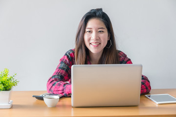 Happy businesswoman working typing in a laptop in a office with copy space