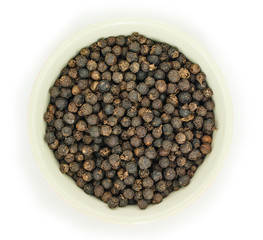 peppercorns in bowl top view on white background.