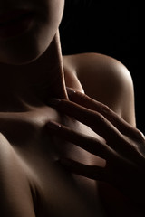 sensual female topless body on black background