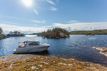 Fototapeta na wymiar White motor boats in the parking lot near the islands in Karelia. Ladoga lake.