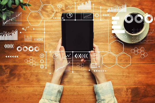 Marketing concept with a person holding a tablet computer - Powered by Adobe