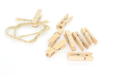 clothes pin and brown rope on white background.