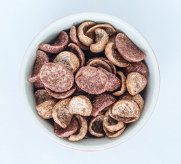 corn flakes cocoa on white bowl on white background.