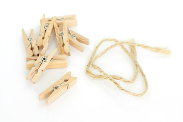 clothes pin and brown rope on white background.