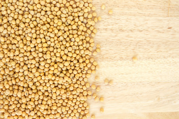 soy bean heap on wooden background top view.