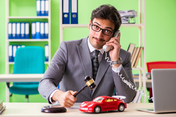 Young handsome lawyer working in the office 