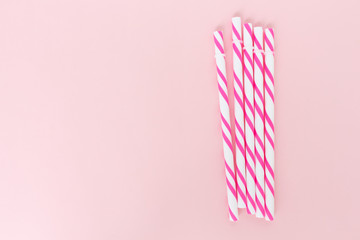 pink striped straws on pink background