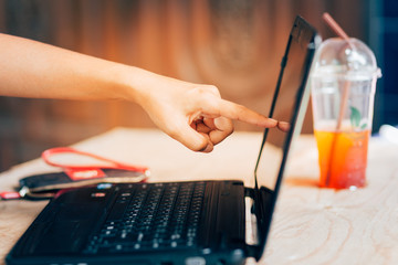 A woman pointing finger to the screen laptop